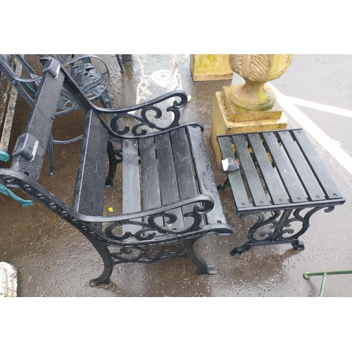 569 - A wooden slatted/cast iron heavy garden seat with foot rest with fitted solar light.  Chair height 6... 