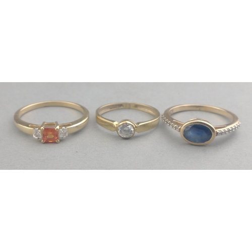 57 - Three 375 stamped rings one with an oval SAPPHIRE and one with a rectangular cut SPESSARTINE GARNET ... 