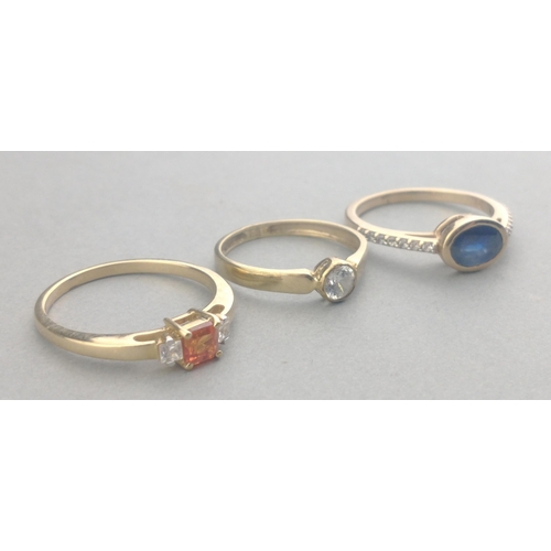 57 - Three 375 stamped rings one with an oval SAPPHIRE and one with a rectangular cut SPESSARTINE GARNET ... 