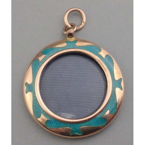 7 - A 9ct stamped enamel pendant locket with monogram. Note damage to enamel on rear. Three cm diameter ... 