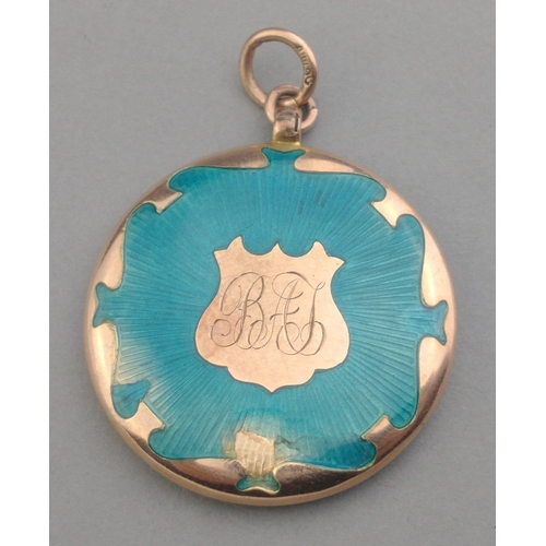 7 - A 9ct stamped enamel pendant locket with monogram. Note damage to enamel on rear. Three cm diameter ... 