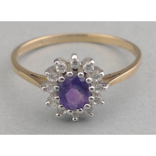 8 - A ladies dress ring stamped 375 and set with cubic zirconia and a central purple stone.  Size O. Gro... 