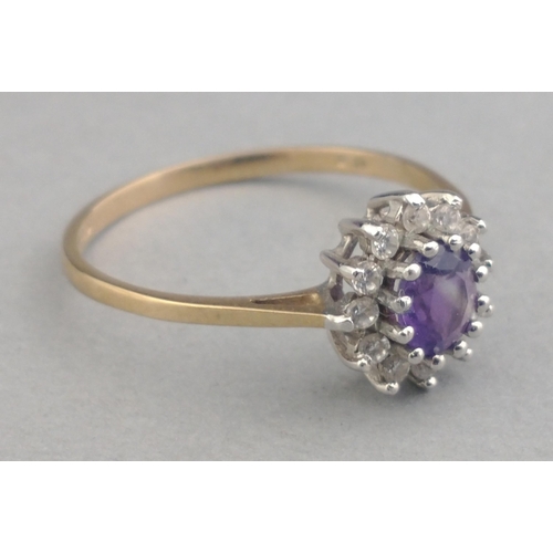 8 - A ladies dress ring stamped 375 and set with cubic zirconia and a central purple stone.  Size O. Gro... 