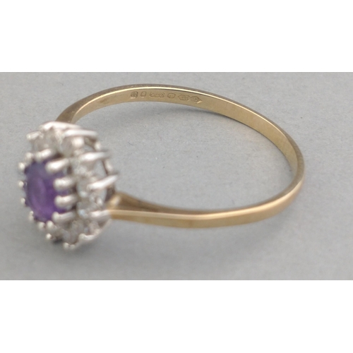 8 - A ladies dress ring stamped 375 and set with cubic zirconia and a central purple stone.  Size O. Gro... 