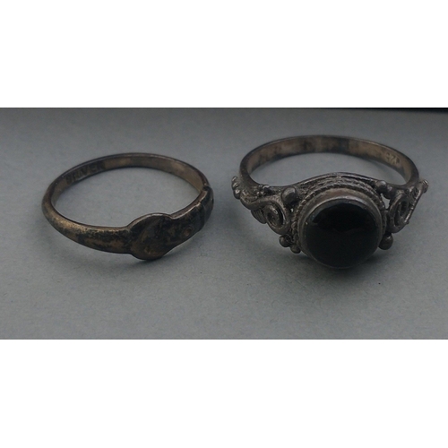 205 - Two silver rings, one set with a dark-coloured stone, size L and G, total gross weight 3g approx.  A... 