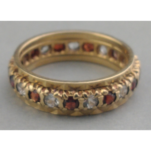 31A - A 375 stamped 9ct gold eternity ring set with white stones and red stones.  Size L. Gross weight 3.3... 