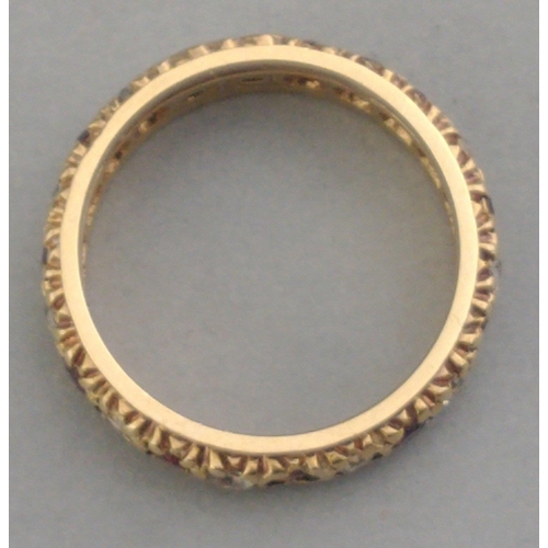 31A - A 375 stamped 9ct gold eternity ring set with white stones and red stones.  Size L. Gross weight 3.3... 