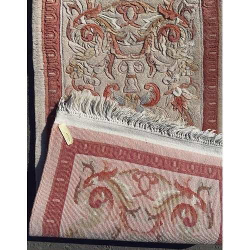 329 - A useful CHINESE wool rug with fringe and pink theme.  140 x 60cm approx.#38