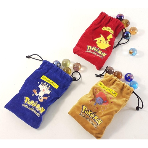 195 - Three little velvet bags of POKEMON marbles.#241