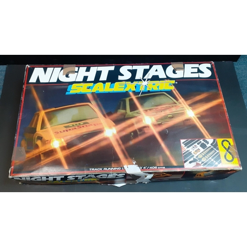 197 - SCALEXTRIC Night Stages set contains cars, controllers and some tracks.  Has been used.#243