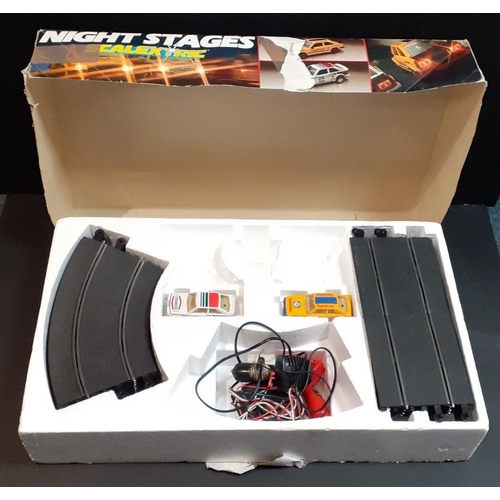 197 - SCALEXTRIC Night Stages set contains cars, controllers and some tracks.  Has been used.#243