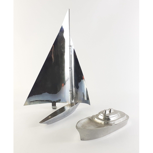 61 - Two aluminium desktop shipping models, the taller yacht stands 38cm approx and the boat 23cm in leng... 