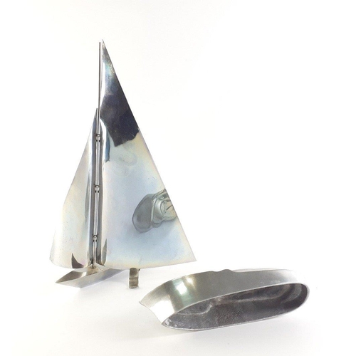 61 - Two aluminium desktop shipping models, the taller yacht stands 38cm approx and the boat 23cm in leng... 