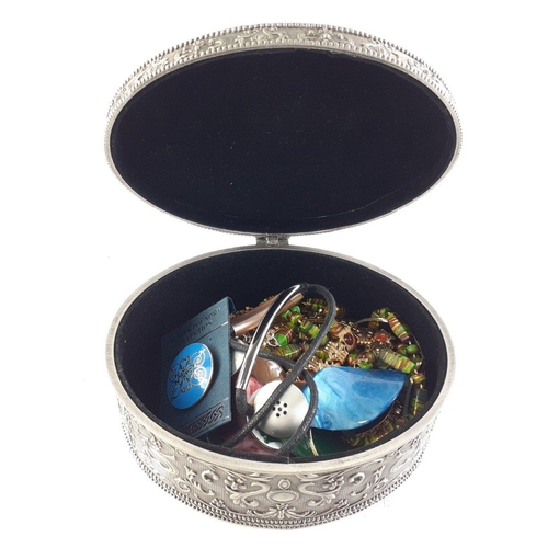 72 - A heavyweight oval metal jewellery box containing enamelled brooches, bangles etc#73