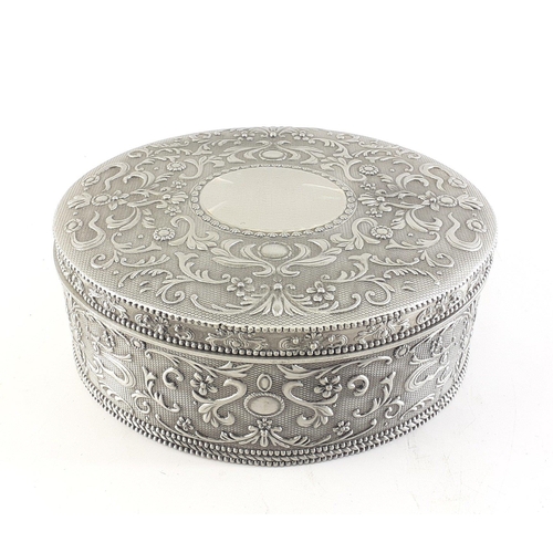 72 - A heavyweight oval metal jewellery box containing enamelled brooches, bangles etc#73
