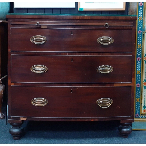 129 - A 19th century bow fronted mahogany three drawer chest of drawers with a concealed pull-out correspo... 