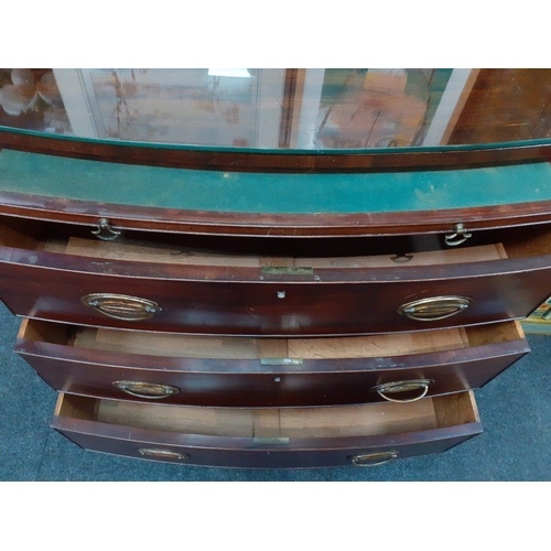129 - A 19th century bow fronted mahogany three drawer chest of drawers with a concealed pull-out correspo... 