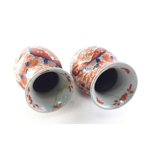 309 - ANTIQUE JAPANESE - An attractive pair of Japanese Imari vases each 31cm high.  Both have historic re... 