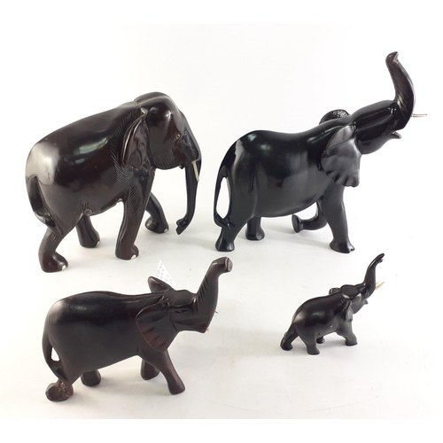319 - A set of four ebonised carved African Elephants. Nice group with some wear but displays well. Larges... 