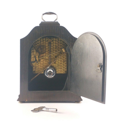 177 - A GARRARD oak case mantle clock with chime control lever. With pendulum, and original GARRARD brande... 