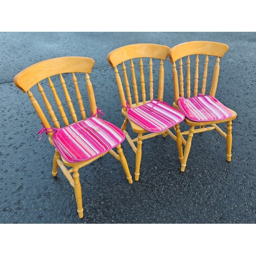 226 - Three matching wooden kitchen chairs with pads.#252