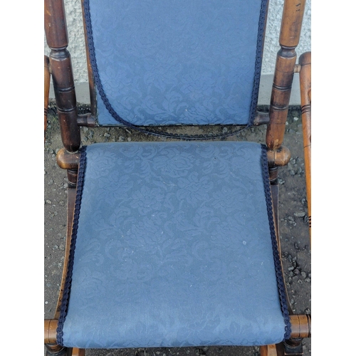 227 - A late Victorian beechwood American rocking chair with blue floral fabric covering. Height 103cm app... 