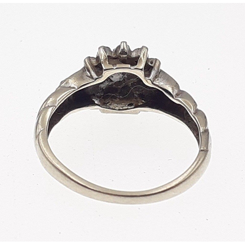 3 - A 375 fully marked white gold ring set with a diamond cluster of small stones (some missing).  Size ... 