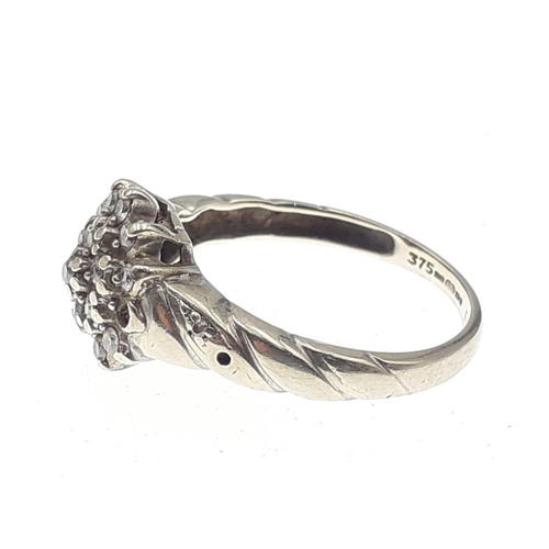 3 - A 375 fully marked white gold ring set with a diamond cluster of small stones (some missing).  Size ... 