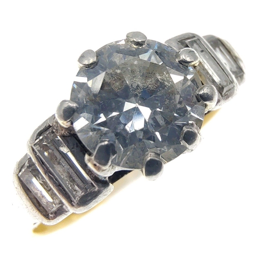 30 - A stunning Diamond ring with a 5.3mm centre stone and four baguette shoulder diamonds.  The shaft ap... 