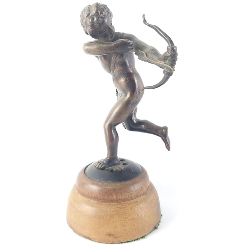 365 - An exceptionally well sculpted small bronze model of Cupid on wooden plinth. Stands 15cm tall. Unsig... 
