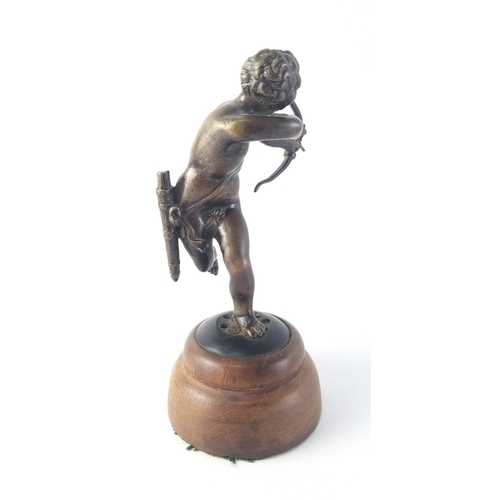 365 - An exceptionally well sculpted small bronze model of Cupid on wooden plinth. Stands 15cm tall. Unsig... 