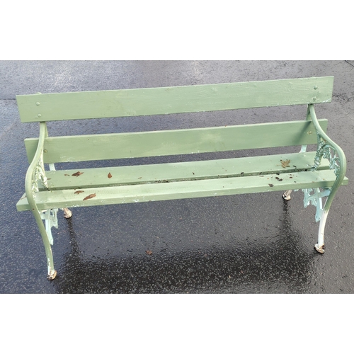 481 - A wrought iron two seater garden bench in good usable condition painted green#509