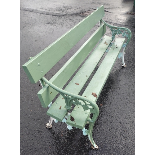 481 - A wrought iron two seater garden bench in good usable condition painted green#509