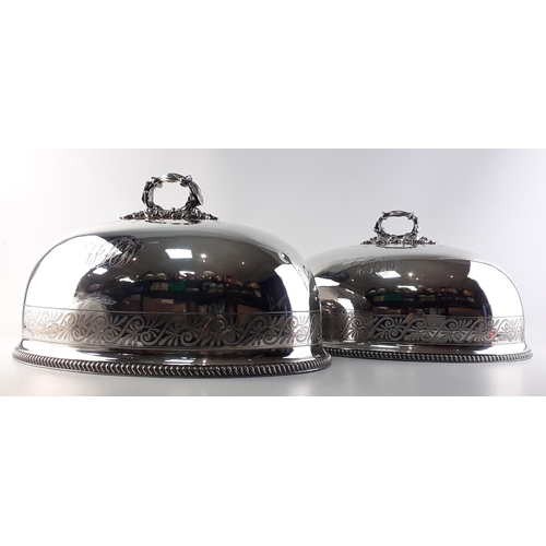 80 - Two very large plated meat covers with ornate acorn leaf handles and monograms.The largest 45cm acro... 