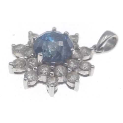 20 - A rare BLUE DIAMOND pendant set in a floral bed of twenty white diamonds set on a 14K white gold mou... 