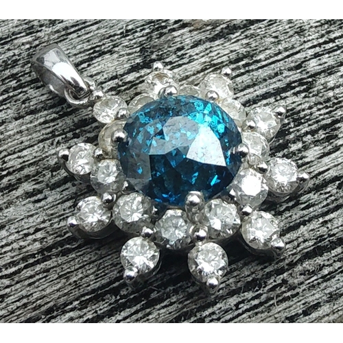 20 - A rare BLUE DIAMOND pendant set in a floral bed of twenty white diamonds set on a 14K white gold mou... 