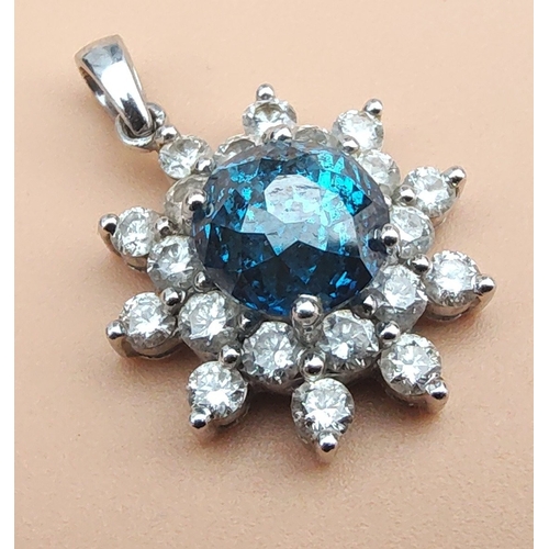 20 - A rare BLUE DIAMOND pendant set in a floral bed of twenty white diamonds set on a 14K white gold mou... 