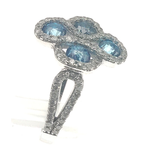 25 - A four stone BLUE DIAMOND ring set in 14K mount with multiple small diamonds. Each blue Diamond appr... 