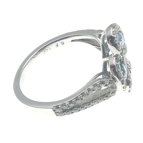 25 - A four stone BLUE DIAMOND ring set in 14K mount with multiple small diamonds. Each blue Diamond appr... 