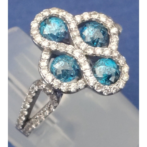 25 - A four stone BLUE DIAMOND ring set in 14K mount with multiple small diamonds. Each blue Diamond appr... 