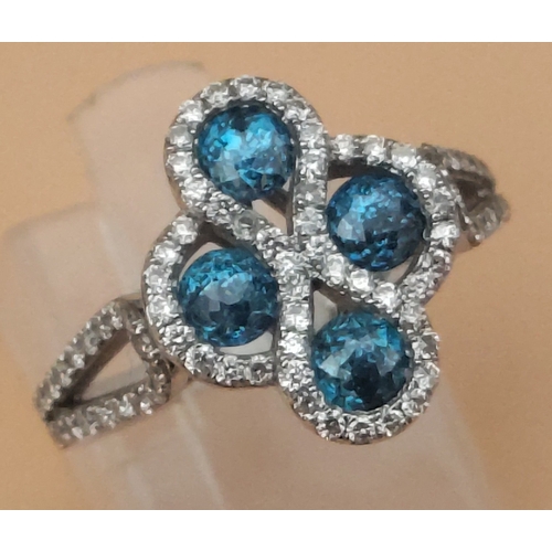 25 - A four stone BLUE DIAMOND ring set in 14K mount with multiple small diamonds. Each blue Diamond appr... 