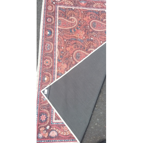 254 - A modern made PAISLEY pattern carpet 150cm x 90cm. A good usable piece.