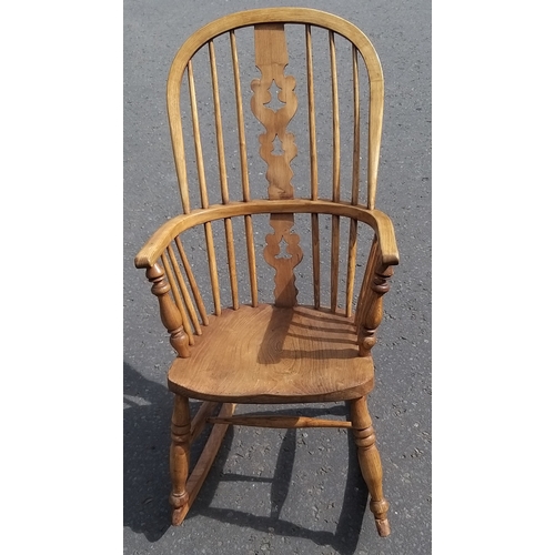 265 - An antique Windsor style carved and pierced  back ROCKING CHAIR.  Stands 105cm tall at back and in g... 