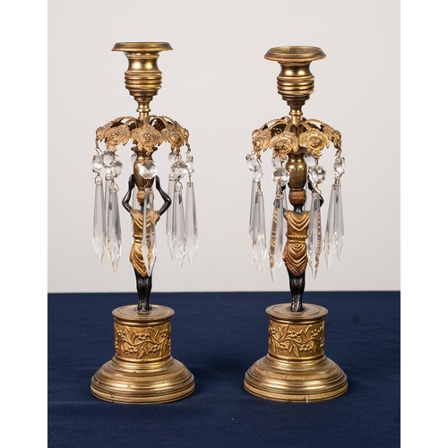 89 - PAIR OF REGENCY PATINATED AND GILT BRONZE FIGURAL CANDLESTICKS, each modelled a Blackamoor supportin... 