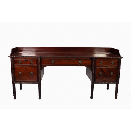 130 - GEORGE III CARVED MAHOGANY INVERTED BREAKFRONT LARGE SIDEBOARD, the rope twist moulded shaped top su... 