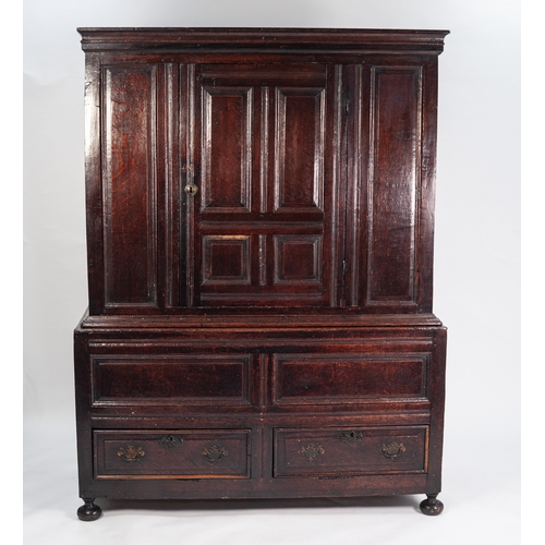 110 - LATE 17th CENTURY PANELLED OAK TWO PART CUPBOARD, the upper section with moulded cornice above a cen... 