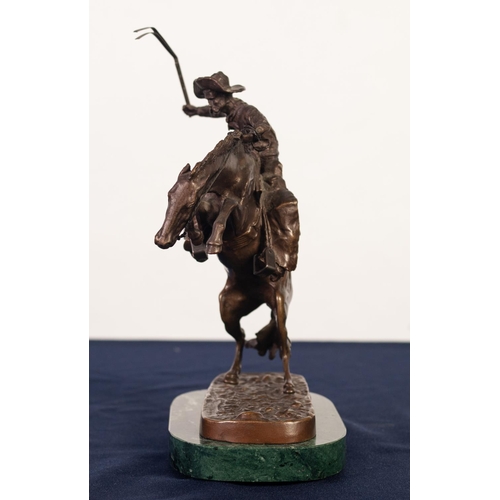 82 - AFTER FREDERICK REMMINGTON, BRONZE GROUP, ‘BRONCO BUSTER’, modelled as a cowboy with whip on a reari... 