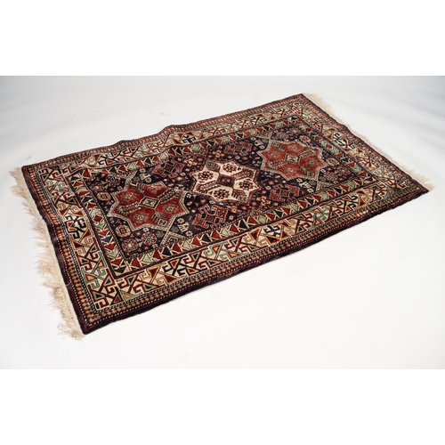 5 - PAIR OF CAUCASIAN RUGS, WITH THREE CHAIN MEDALLIONS OF EIGHT POINT STAR PATTERN, on a midnight blue ... 