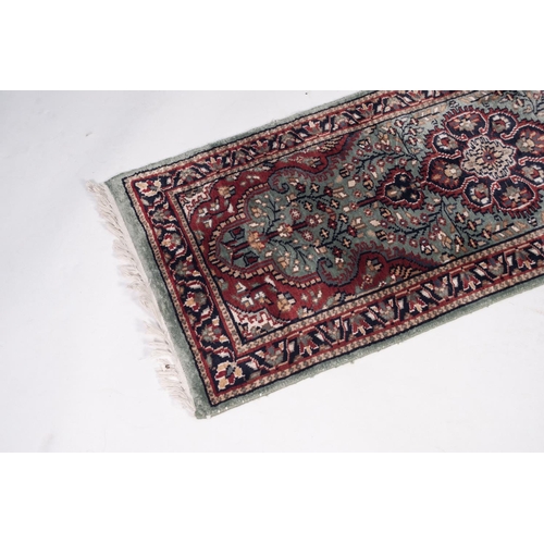 7 - EASTERN SILKY PILE SMALL, BORDERED RUNNER with petal pattern centre medallion with pendants, on a li... 