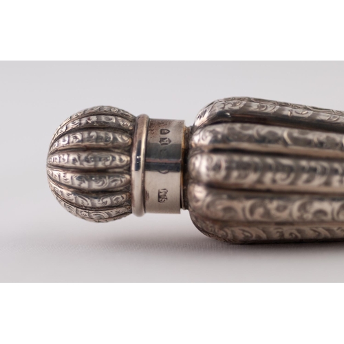 11 - A LATE VICTORIAN SILVER SCENT FLASK, of tapered ribbed form with screw-on top chased with foliate sc... 